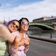 Cool portrait of cheerful friends in Paris, near to Seine river.