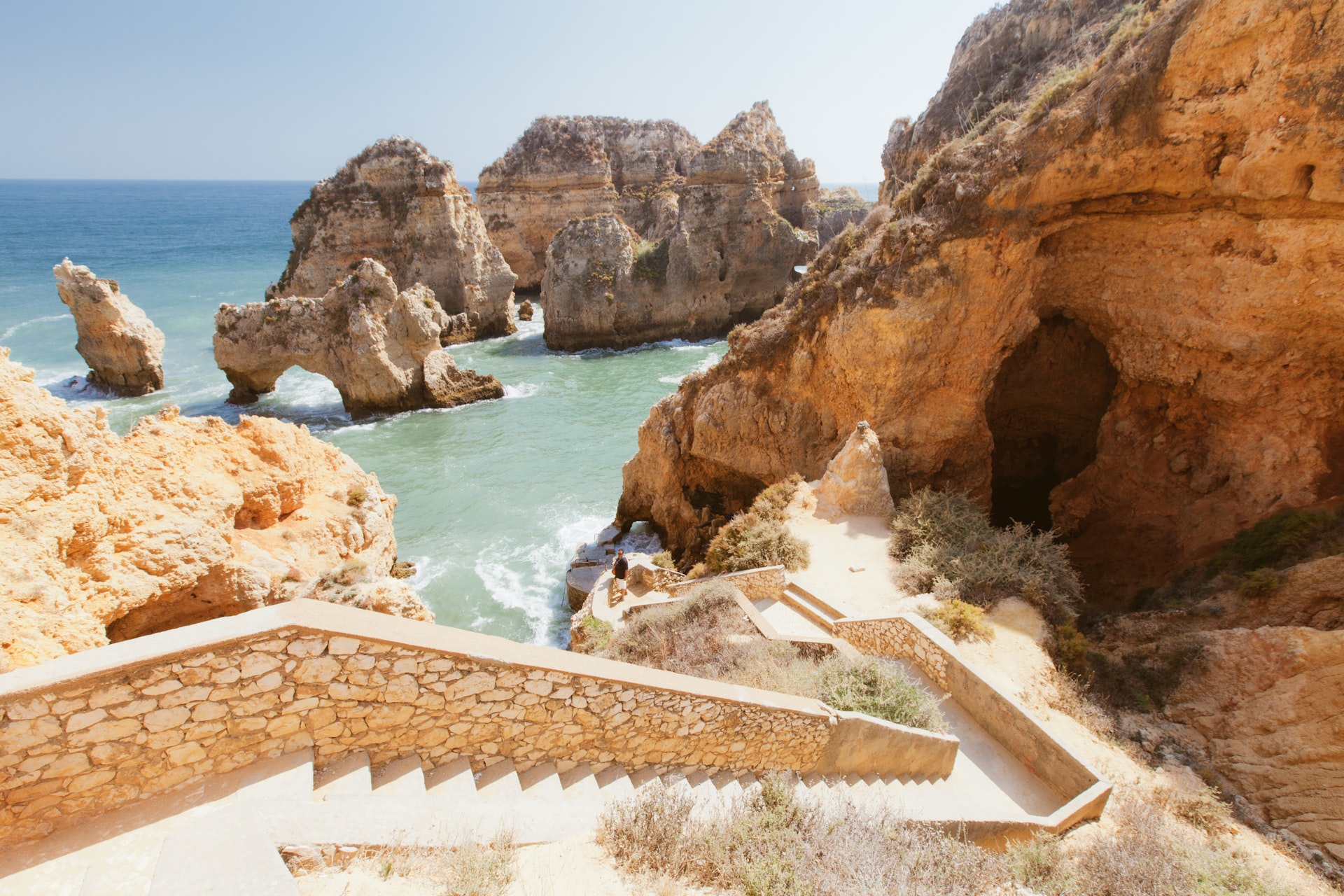 Rocky cliff seascape with steps to beach in Lagos, Algarve, Portugal. Ponta Da Piedade Beach in Lagos.