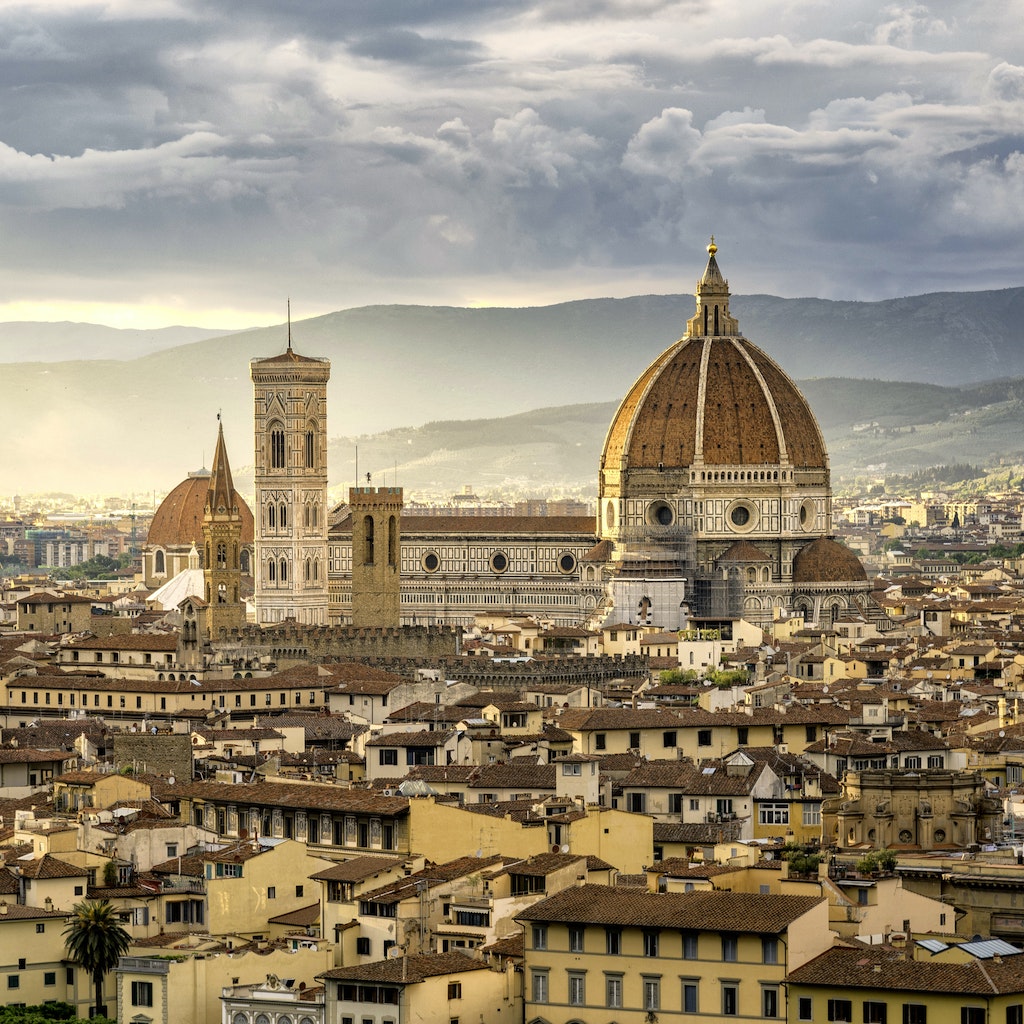 Exterior of the Santa Maria Novella Duomo and the town of Florence during sunset.