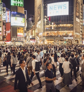Crowds of people on Shinjuku Crossing.